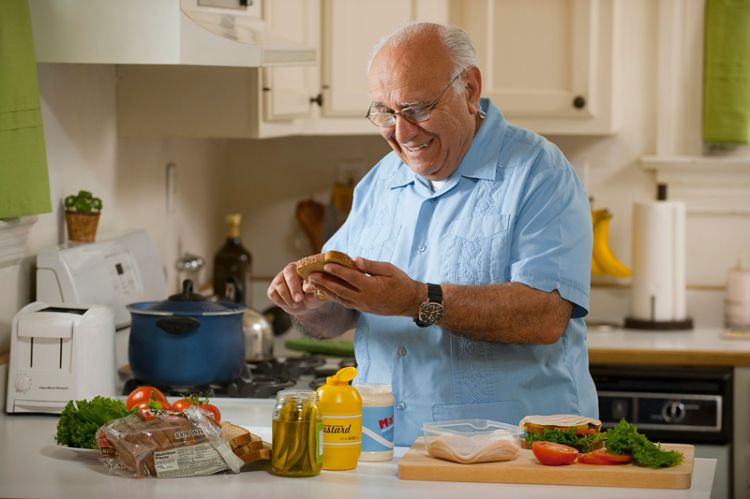 An older person preparing a meal. Source: USDA SNAP-Ed Connection