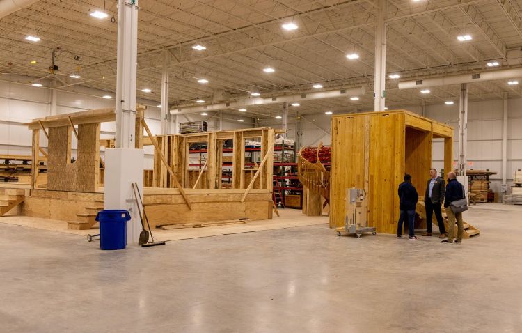 Big warehouse space with wood structures being built.
