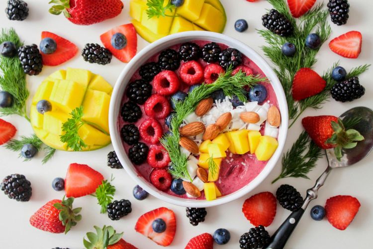 Colorful fruit and herb smoothie bowl.