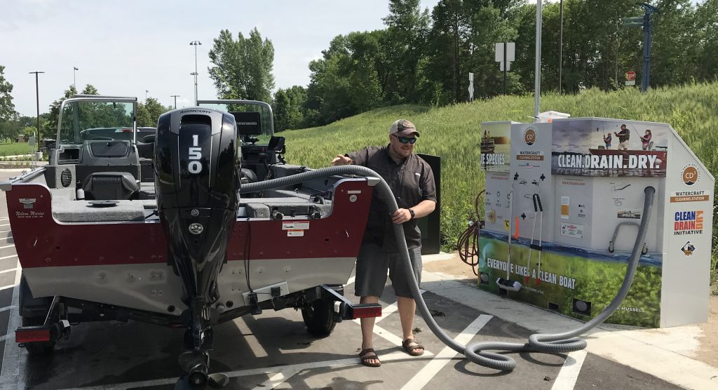 Person utilizing waterless cleaning system for boat.