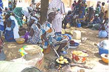 woman at a market selling beans